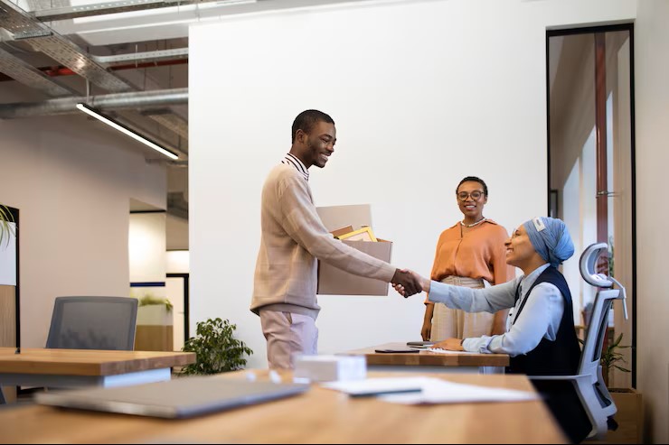 man with box belongings being introduced coworkers his new job 23 2149034542